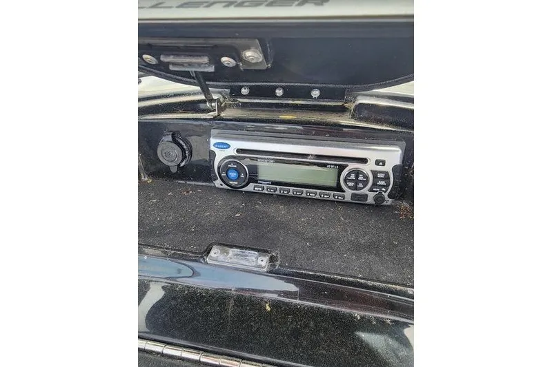 Slide: The Image of 2012 Sea-Doo 180 Challenger boat stereo system in dashboard compartment. - 23