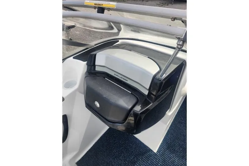 Slide: The Image of 2012 Sea-Doo 180 Challenger boat dashboard with storage compartment and cup holder. - 26