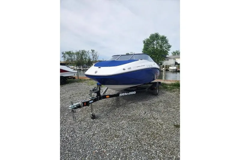 Slide: The Image of 2012 Sea-Doo Sport Boats 180 Challenger on trailer, parked outdoors near water. - 4