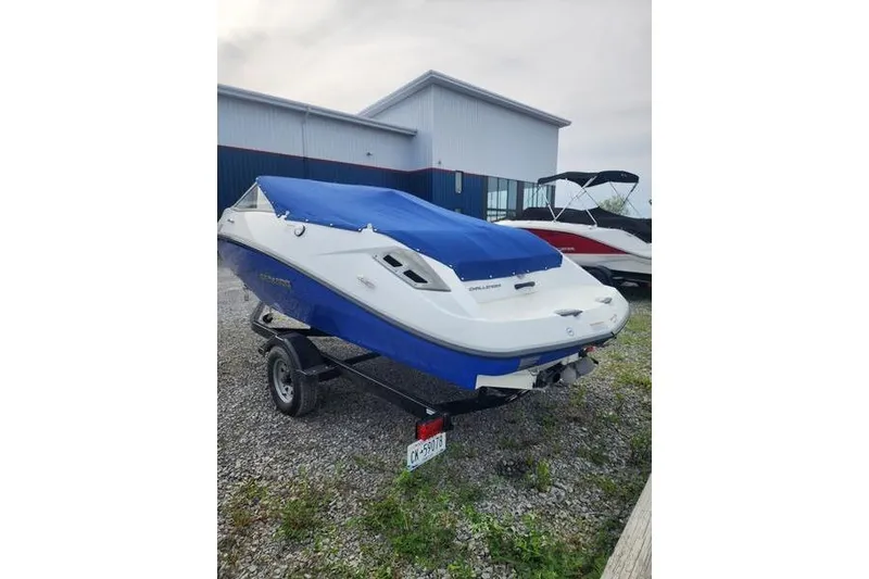 Slide: The Image of 2012 Sea-Doo Sport Boats 180 Challenger with blue cover on trailer. - 5