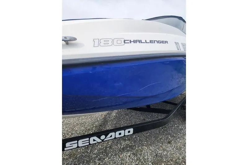 Slide: The Image of 2012 Sea-Doo Sport Boats 180 Challenger, blue and white hull, on a trailer. - 6