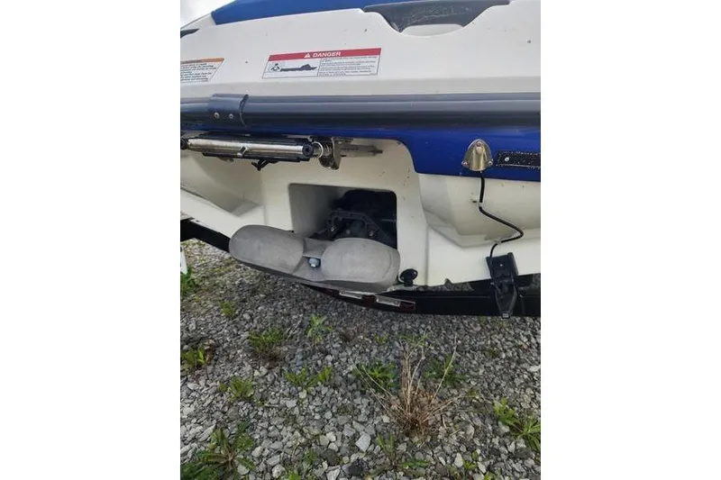 Slide: The Image of 2012 Sea-Doo Sport Boats 180 Challenger rear view, showing engine compartment and warning labels. - 7
