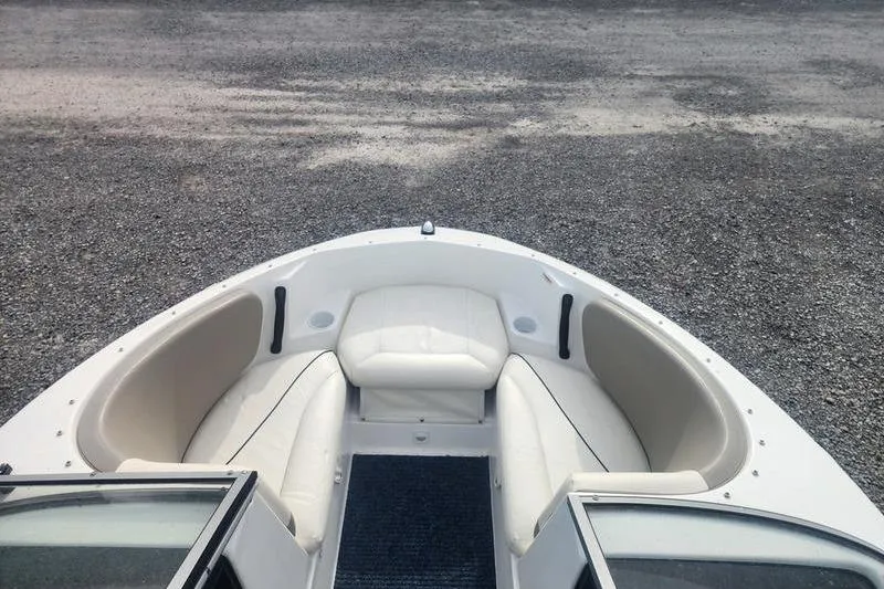 Slide: The Image of 2012 Sea-Doo 180 Challenger boat interior with white seating and open bow design. - 8