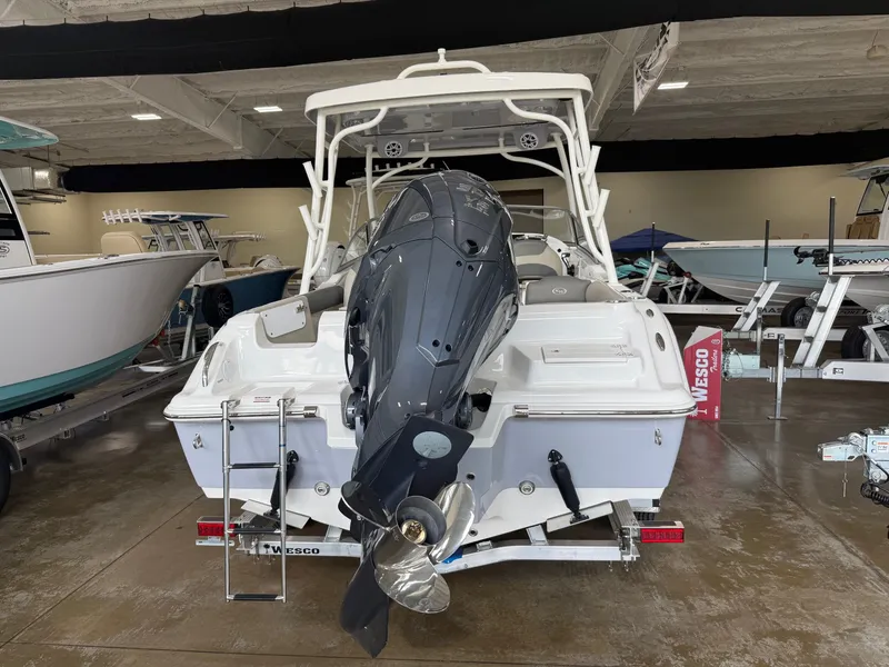 Slide: The Image of Key West 239 DFS boat 2026 in showroom with outboard motor. - 9