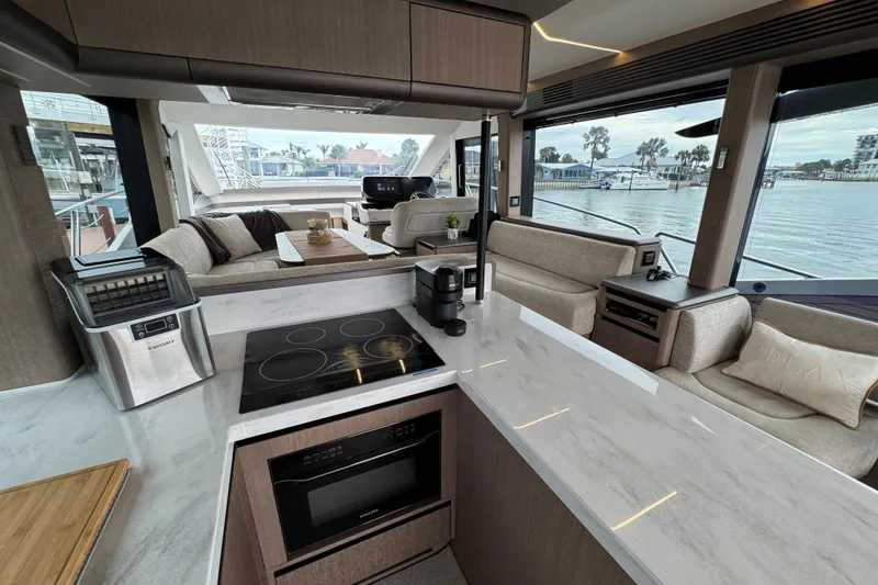 Slide: The Image of Modern interior of 2024 Galeon 560 Fly yacht with sleek kitchen and spacious seating area. - 24