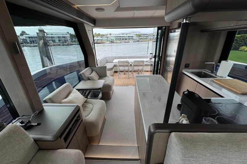 Slide: The Image of Luxurious interior of 2024 Galeon 560 Fly yacht with modern kitchen and seating area. - 27