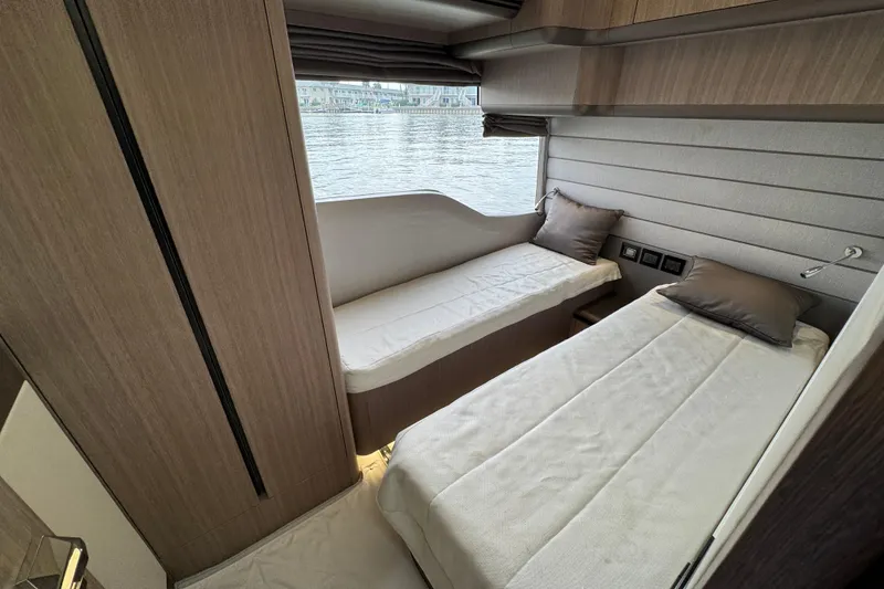 Slide: The Image of 2024 Galeon 560 Fly yacht cabin with twin beds and waterfront view. - 36