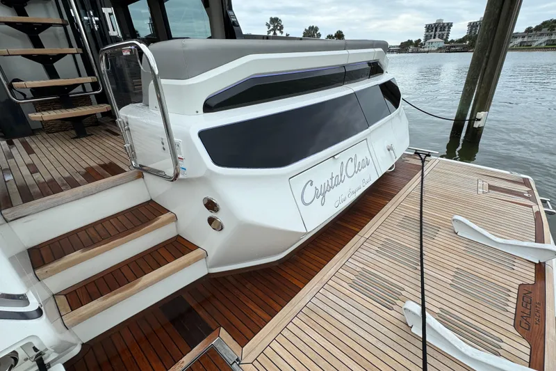 Slide: The Image of 2024 Galeon 560 Fly yacht with teak deck, docked by the water. - 57