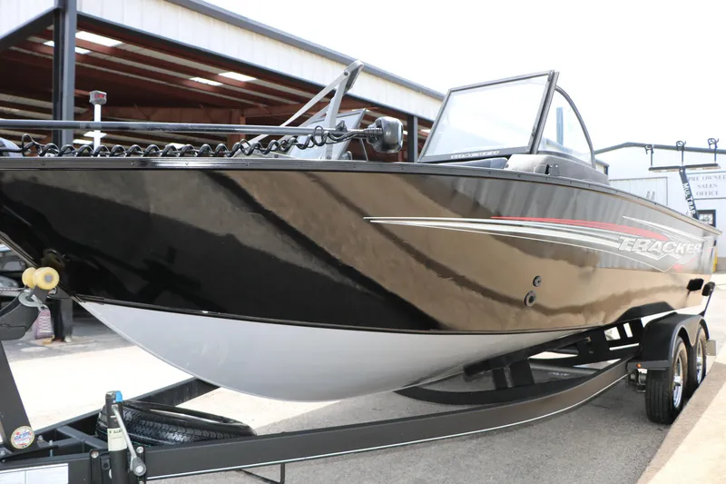 Slide: The Image of 2022 Tracker Targa V-19 Combo boat on trailer, black and white exterior. - 15