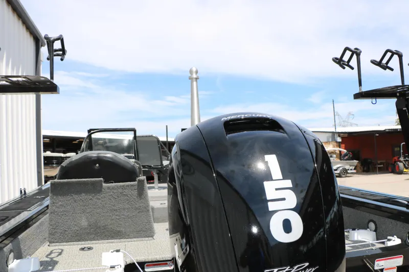 Slide: The Image of 2022 Tracker Targa V-19 Combo boat with Mercury 150 engine in a marina setting. - 25