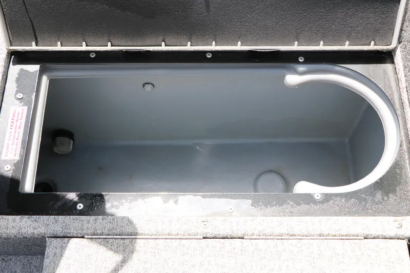 Slide: The Image of Livewell compartment in a 2022 Tracker Targa V-19 Combo boat, featuring a pump-out feature. - 32