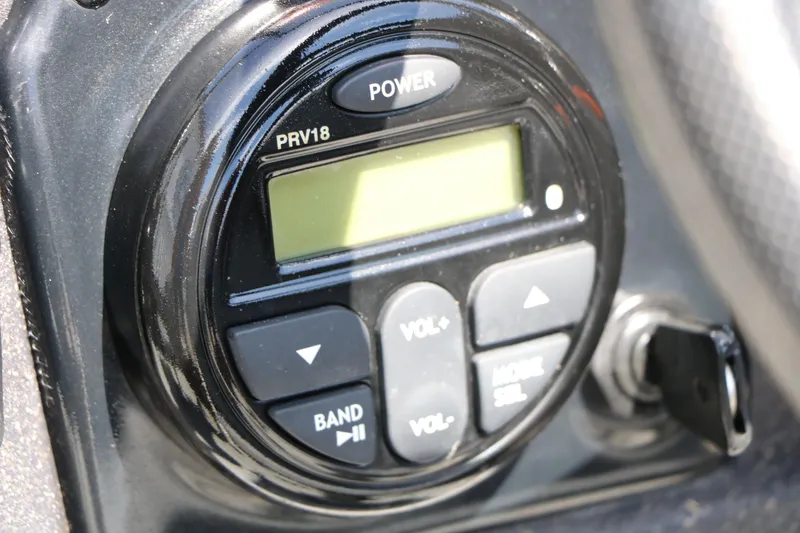 Slide: The Image of Close-up of a 2022 Tracker Targa V-19 Combo boat audio control panel. - 33