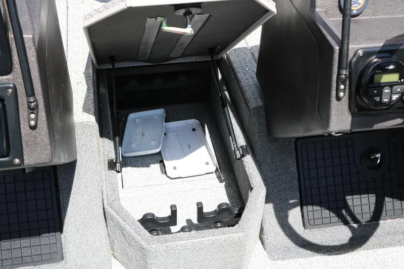 Slide: The Image of 2022 Tracker Targa V-19 Combo boat storage compartment with open lid and accessories. - 34