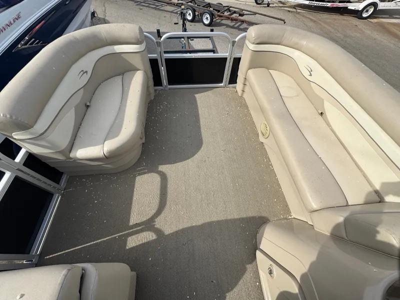Slide: The Image of Interior of a 2014 Bennington 20SLM pontoon boat with beige seating. - 11