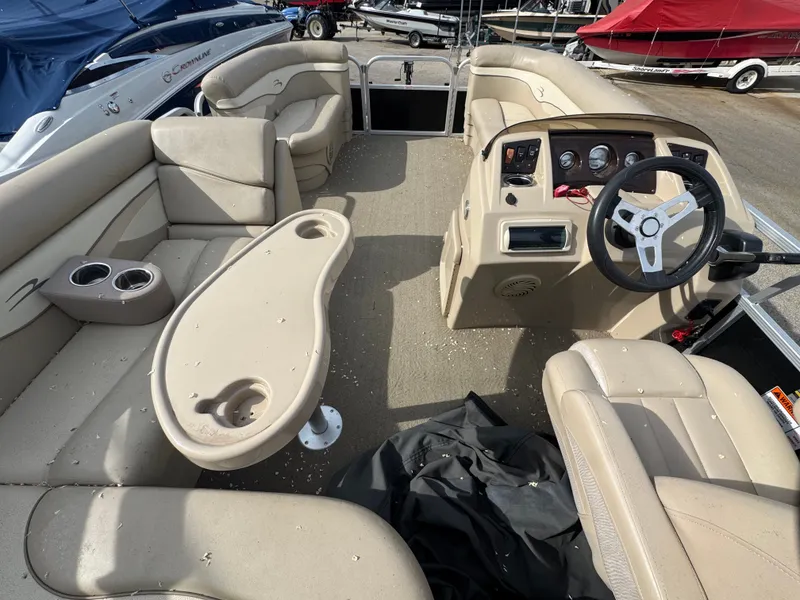 Slide: The Image of Interior of a 2014 Bennington 20SLM pontoon boat with steering wheel and seating. - 7