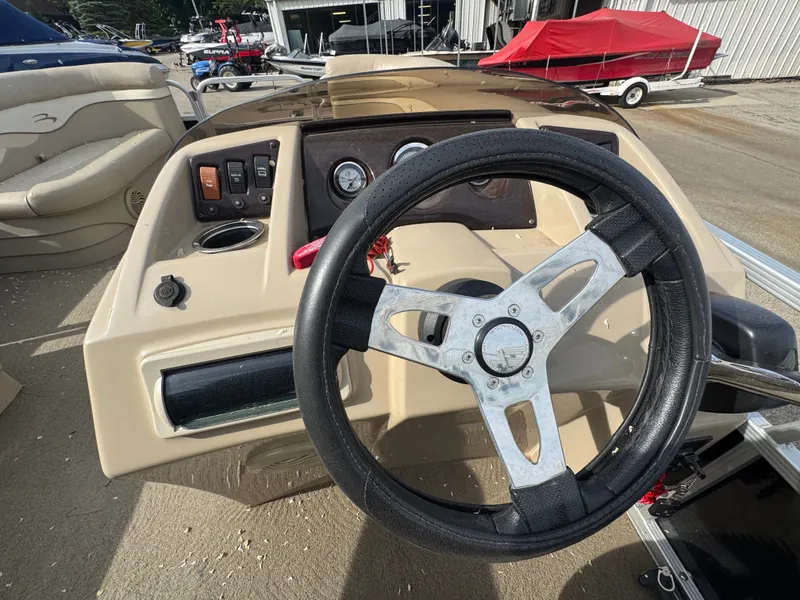 Slide: The Image of Steering wheel and dashboard of a 2014 Bennington 20SLM boat. - 8