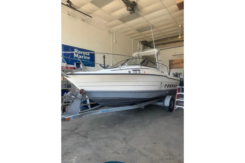 The Image of 1992 Bayliner 2052 Trophy Walkaround boat on trailer in a garage. - 0