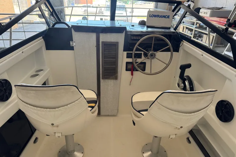 Slide: The Image of Interior of 1992 Bayliner 2052 Trophy Walkaround boat with steering wheel and seats. - 14