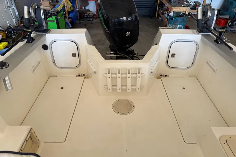 Slide: The Image of 1992 Bayliner 2052 Trophy Walkaround boat interior with fishing rod holders and storage compartments. - 15