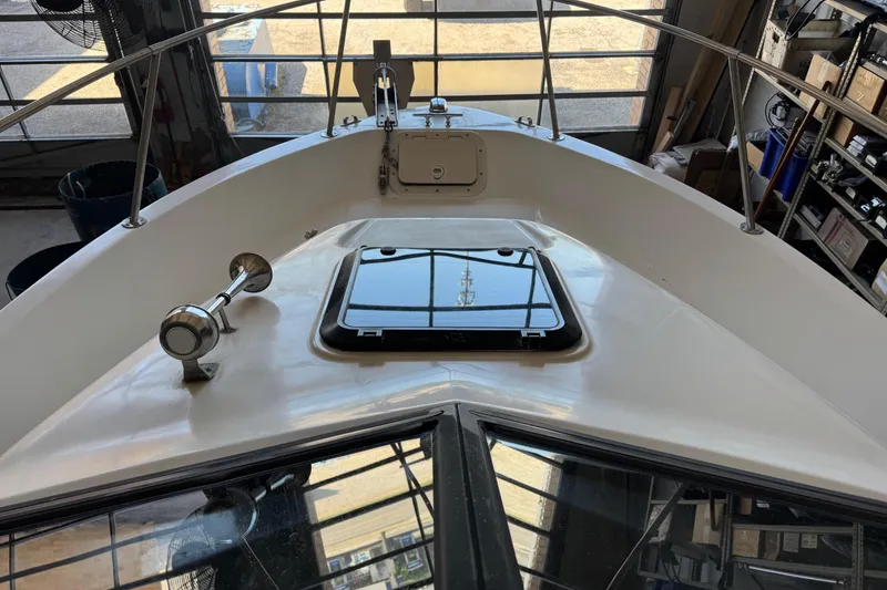 Slide: The Image of 1992 Bayliner 2052 Trophy Walkaround boat deck with hatch and railing in a garage setting. - 17