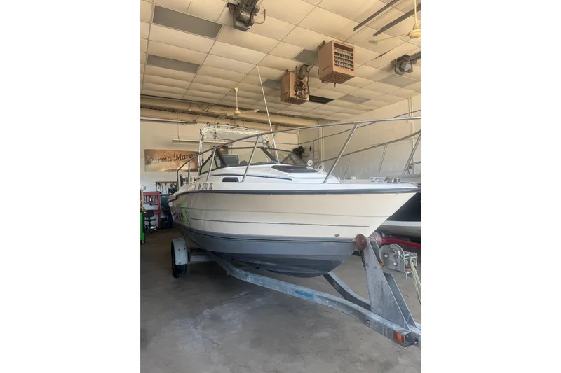 Slide: The Image of 1992 Bayliner 2052 Trophy Walkaround boat on trailer in indoor storage. - 2