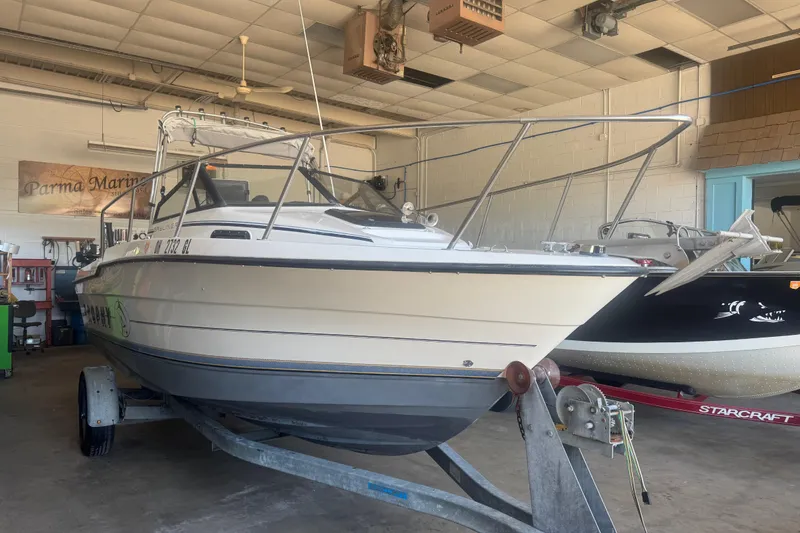 Slide: The Image of 1992 Bayliner 2052 Trophy Walkaround boat on trailer in indoor marina setting. - 3