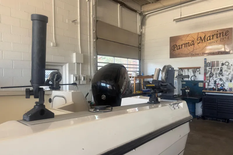 Slide: The Image of 1992 Bayliner 2052 Trophy Walkaround in a marine workshop, featuring equipment and tools. - 4
