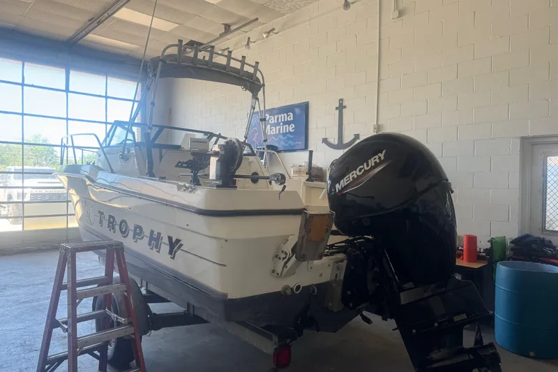 Slide: The Image of 1992 Bayliner 2052 Trophy Walkaround boat with Mercury engine in a garage setting. - 5