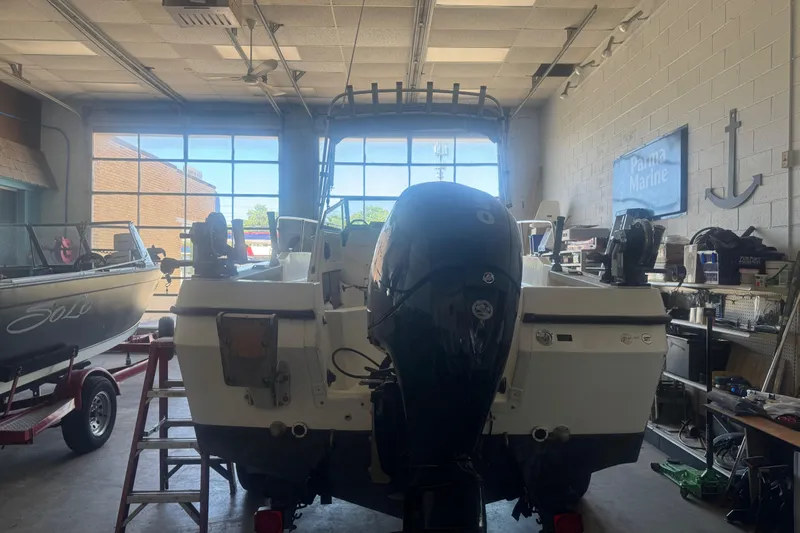 Slide: The Image of 1992 Bayliner 2052 Trophy Walkaround boat in a garage, rear view with outboard motor. - 6