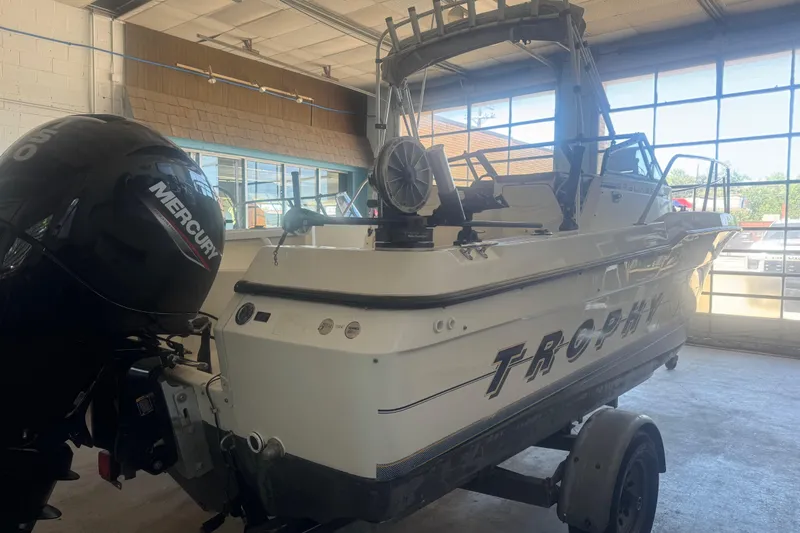 Slide: The Image of 1992 Bayliner 2052 Trophy Walkaround boat with Mercury outboard motor in a garage setting. - 8
