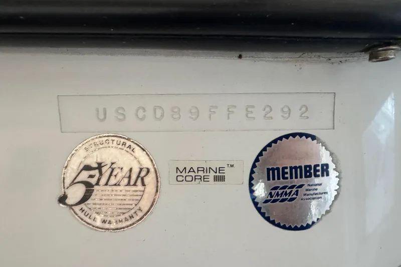 Slide: The Image of Bayliner 2052 Trophy Walkaround 1992 with hull identification and warranty stickers. - 9