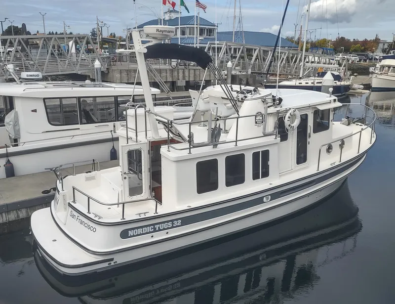 Slide: The Image of 2005 Nordic Tug 32 docked at marina, side view. - 1