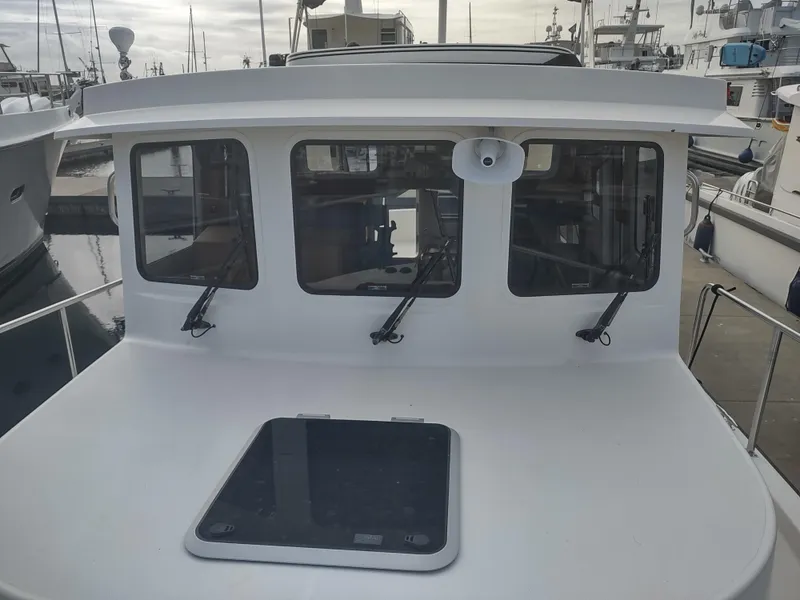 Slide: The Image of 2005 Nordic Tug 32, front view with windows and deck. - 17