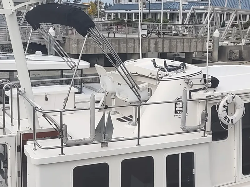 Slide: The Image of 2005 Nordic Tug 32 docked at a marina. - 3