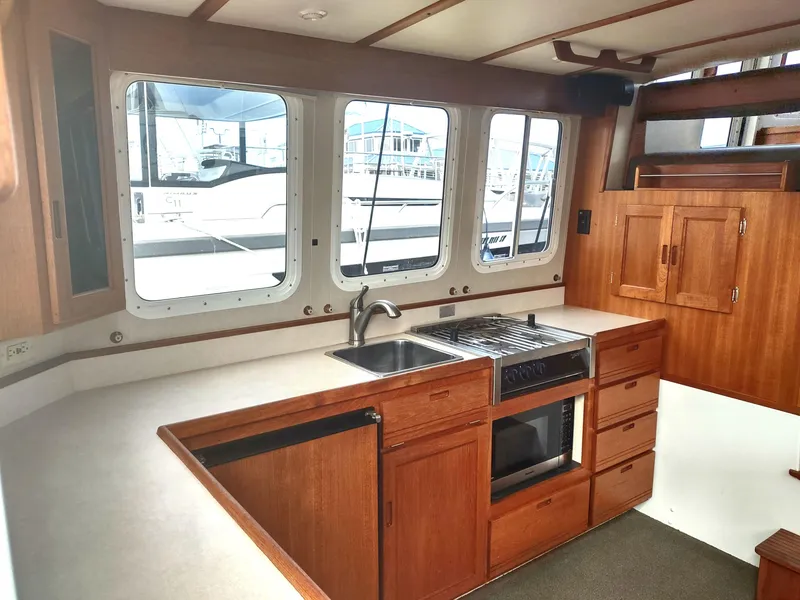 Slide: The Image of Interior of 2005 Nordic Tug 32 featuring kitchen and wood paneling. - 31