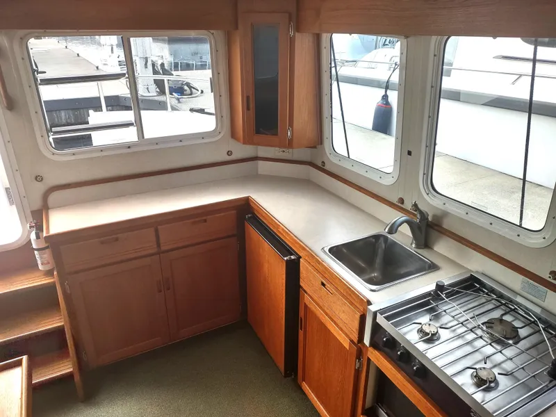 Slide: The Image of Interior of 2005 Nordic Tug 32 featuring kitchen and stove. - 34