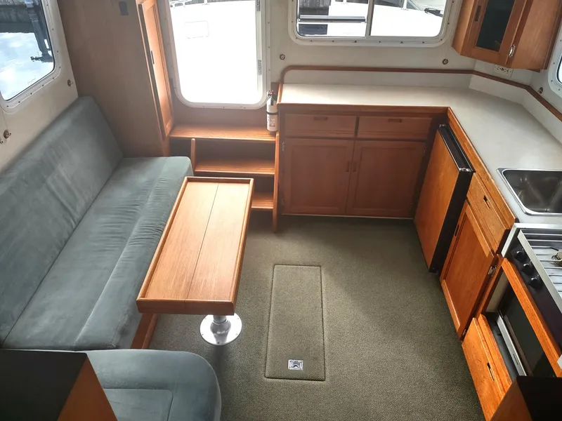 Slide: The Image of Interior of a 2005 Nordic Tug 32 with kitchen and seating area. - 44