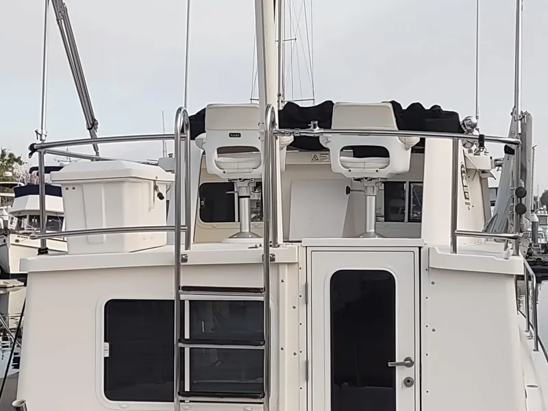 Slide: The Image of Rear view of a 2005 Nordic Tug 32 boat in harbor. - 5