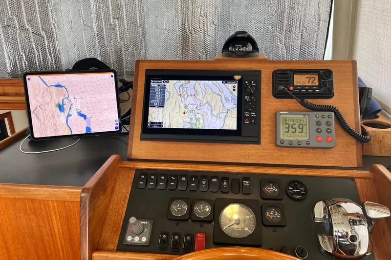 Slide: The Image of Navigation dashboard of a 2005 Nordic Tug 32 with maps and controls. - 51