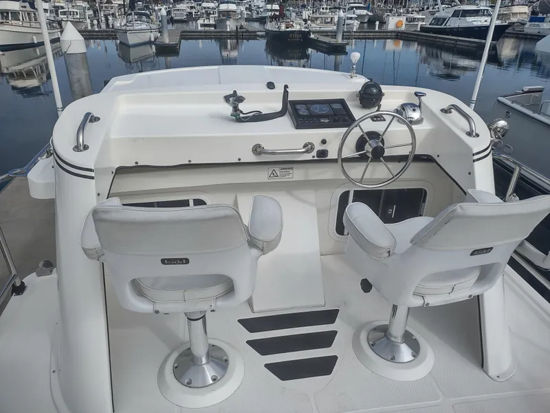 Slide: The Image of Helm of a 2005 Nordic Tug 32 in the marina. - 6