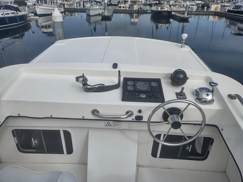 Slide: The Image of Helm of a 2005 Nordic Tug 32 in the marina. - 8