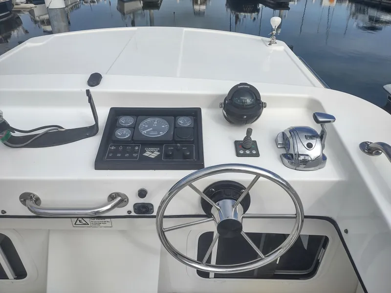 Slide: The Image of Helm of a 2005 Nordic Tug 32 in the marina. - 9