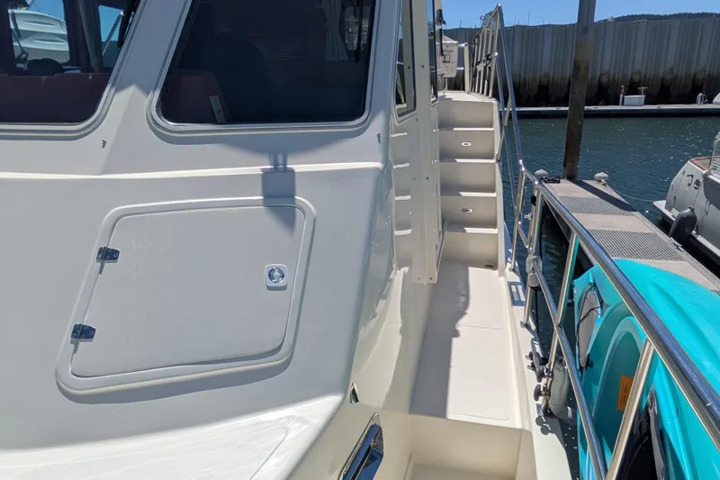 Slide: The Image of 2006 North Pacific 42 Pilothouse yacht, side view with stairs and docked at marina. - 11