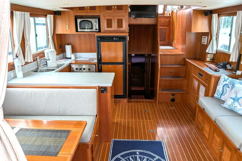 Slide: The Image of Interior of 2006 North Pacific 42 Pilothouse yacht with wood finish and modern amenities. - 18