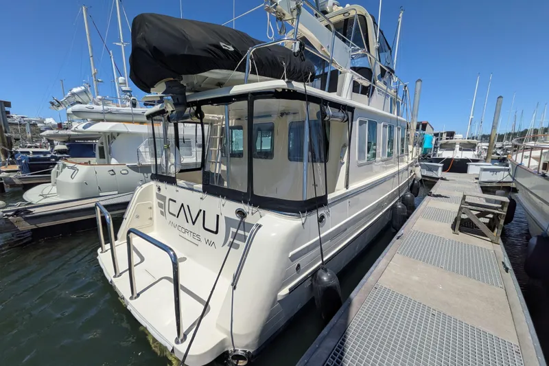 Slide: The Image of 2006 North Pacific 42 Pilothouse docked in Anacortes, WA, under clear blue skies. - 2