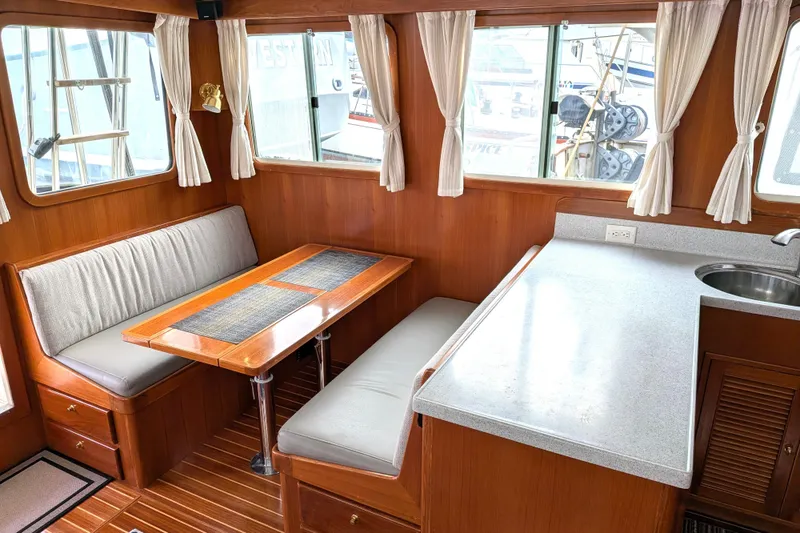 Slide: The Image of Interior of 2006 North Pacific 42 Pilothouse with dining area and kitchenette. - 22