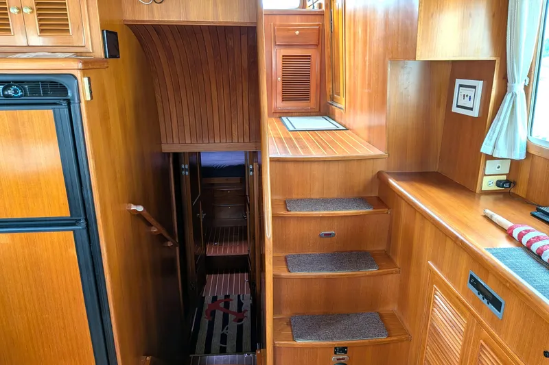 Slide: The Image of Interior of 2006 North Pacific 42 Pilothouse with wooden stairs and cabinetry. - 26