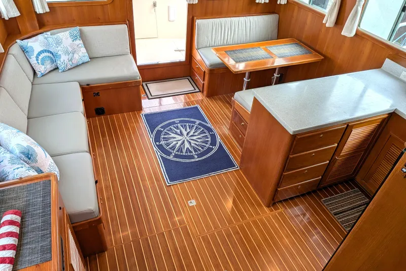 Slide: The Image of Interior of 2006 North Pacific 42 Pilothouse with wood flooring and cozy seating area. - 28