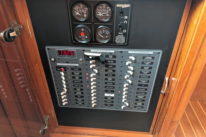 Slide: The Image of Electrical panel of a 2006 North Pacific 42 Pilothouse boat, featuring gauges and switches. - 30