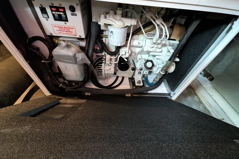 Slide: The Image of Engine compartment of a 2006 North Pacific 42 Pilothouse boat, showing mechanical components. - 35